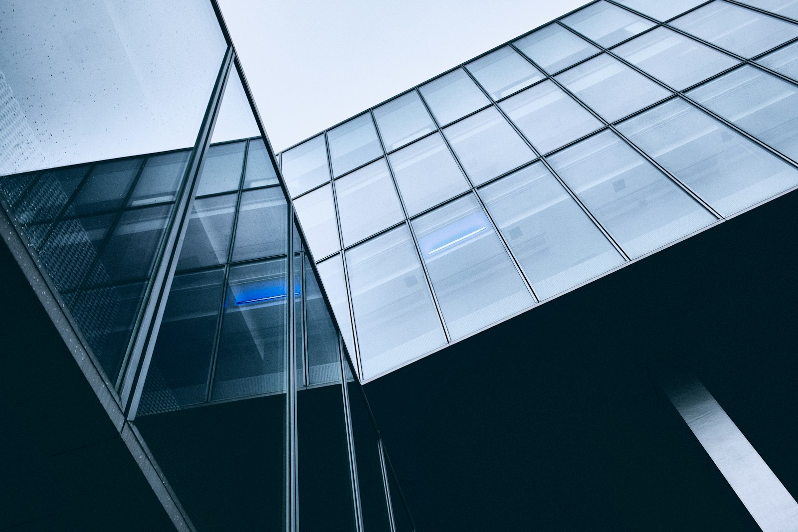 Illustrative glass building facade at dusk